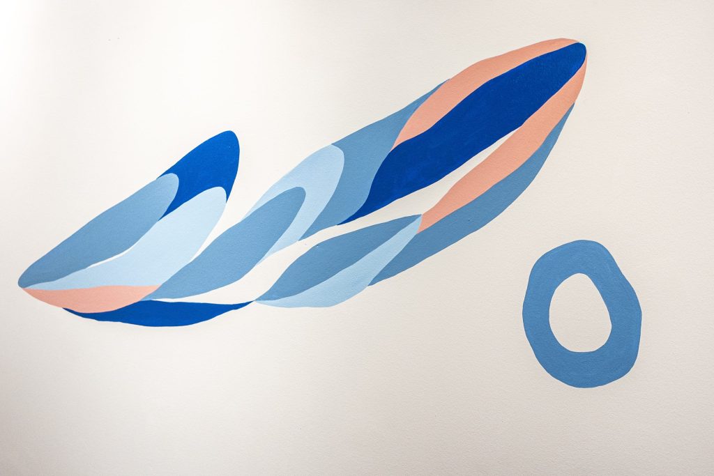 Arashida's organic shapes flowing across Lusa Language School walls, connecting every learning space
