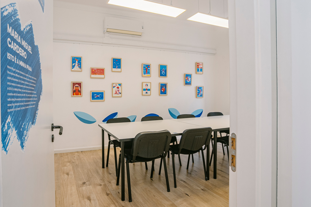Bright Portuguese classroom at Lusa Language School in Lisbon with natural light and artistic wall decorations