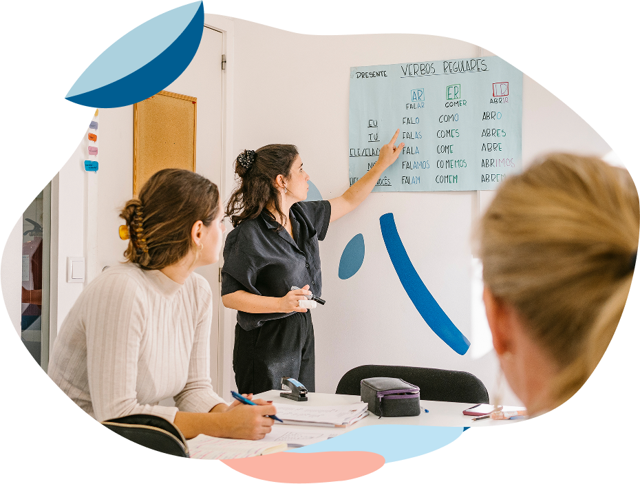 Portuguese teacher explaining a language topic to international students during a group class at Lusa Language School in Lisbon
